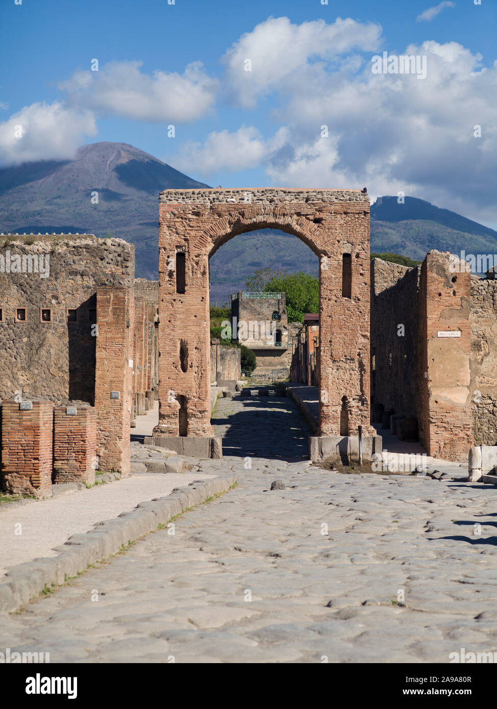 Pompei. Italy. Archaeological site of Pompeii. The so called Arch of Caligula, was the main entrance to Via di Mercurio.  View towards Via di Mercurio Stock Photo