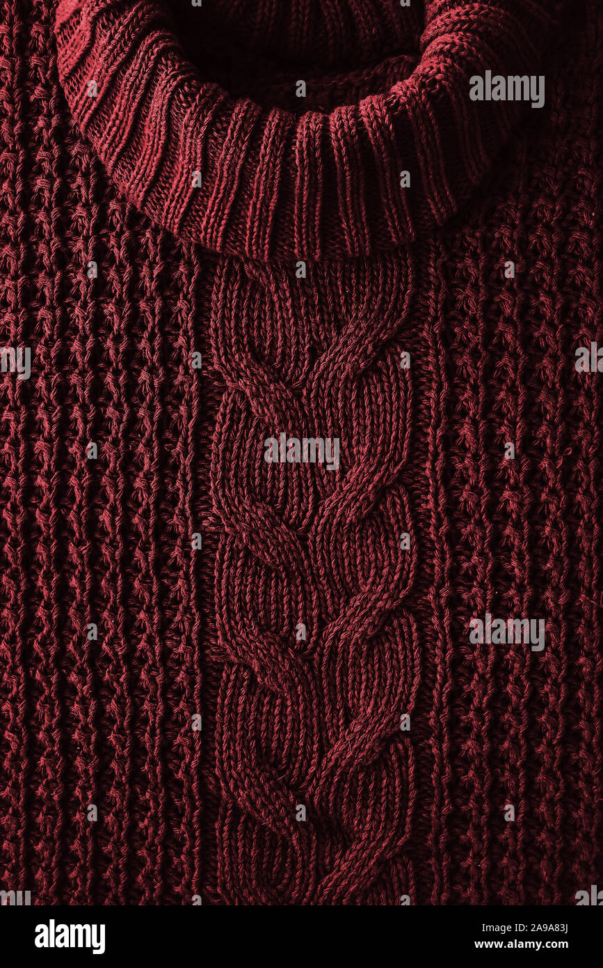 Knitted texture background of a winter red sweater with a high neck. Hipset style. Christmas traditions Stock Photo