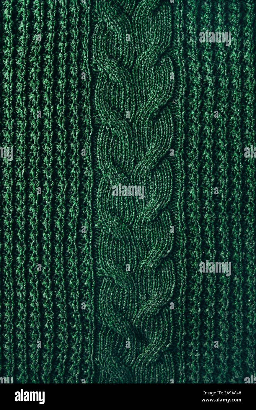 Knitted texture background of a winter green high neck sweater. Hipset style. Christmas traditions Stock Photo