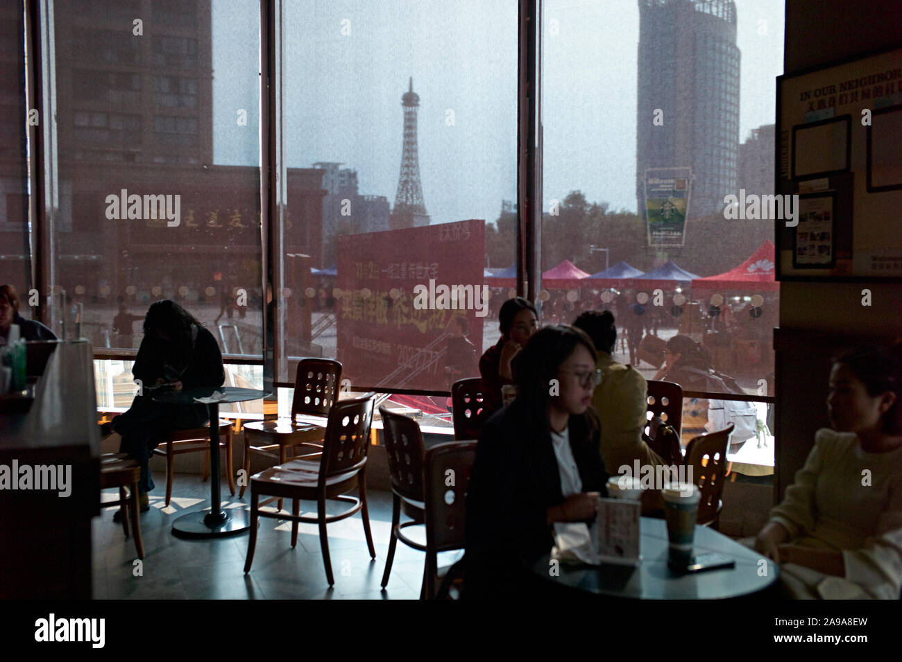 Fake Eiffel tower through the window at Starbuck coffee shop in Lishui, Zhejiang Province China, Stock Photo