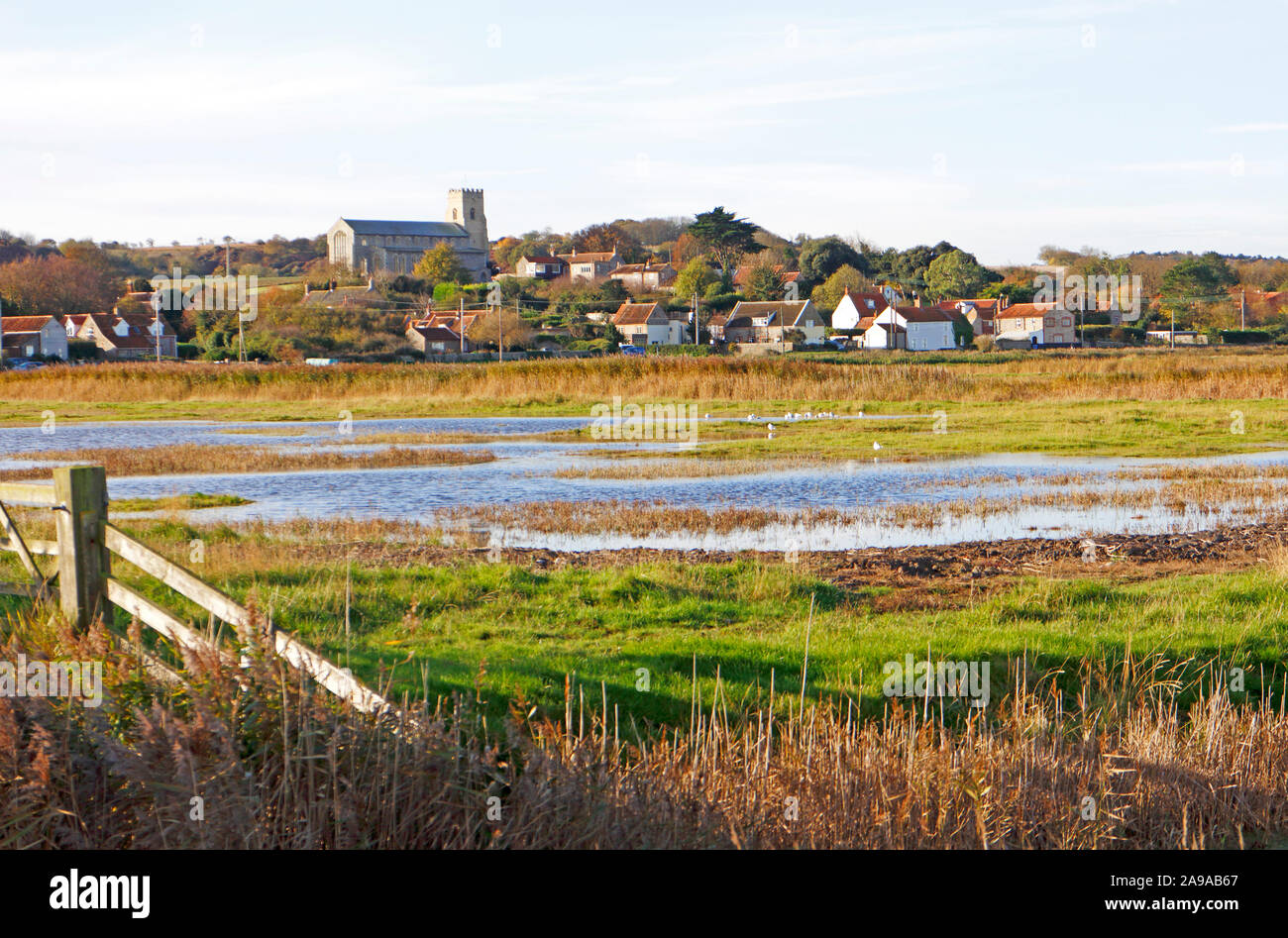 A view over the marshes on the North Norfolk coast to the village of Salthouse, Norfolk, England, United Kingdom, Europe. Stock Photo