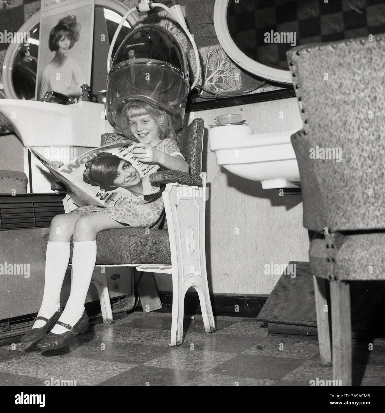 1970s, historical, a young girl sitting in a chair in a professional