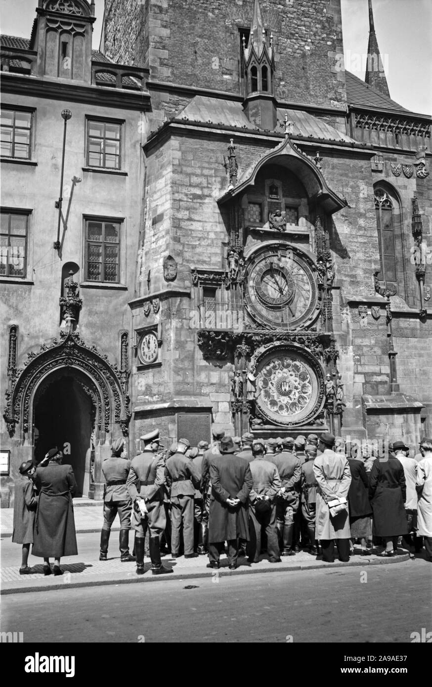 Original caption: German soldiers admire the clock at the town hall in Prague, 1930s Stock Photo