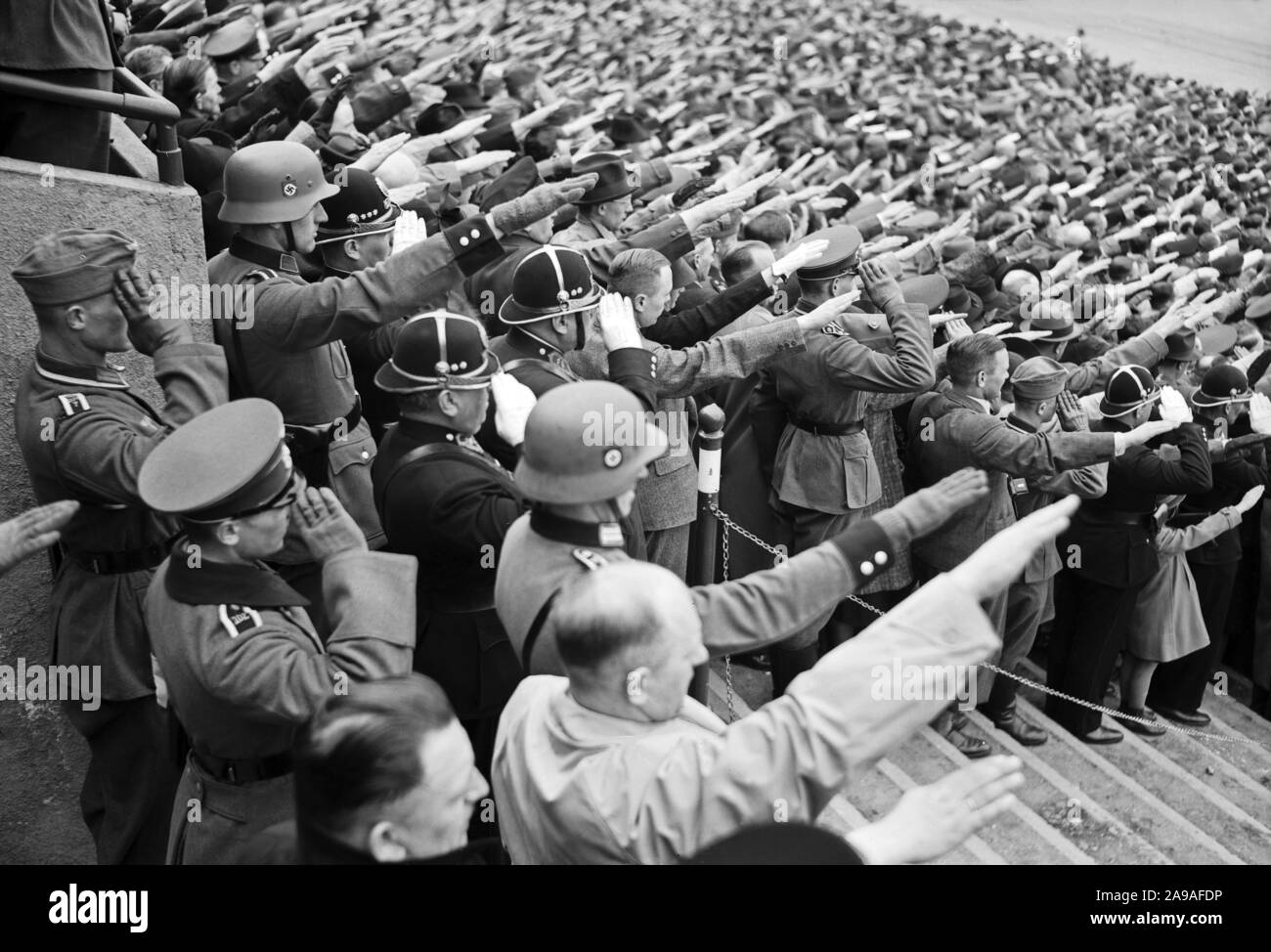 Original caption: Prague, 20 April at Sokol Stadium. With black helmet of Czech police. 1930s Stock Photo
