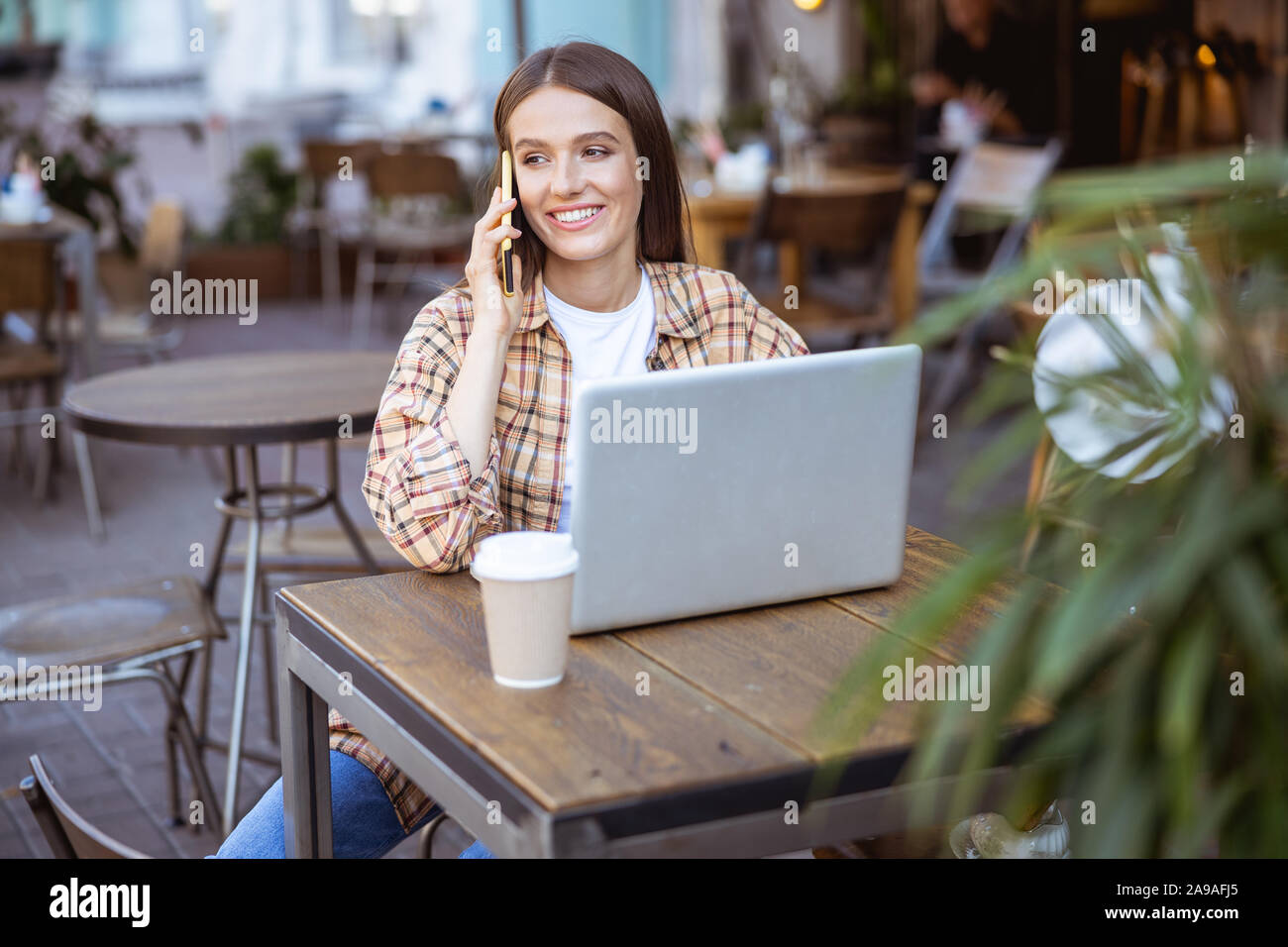 Happy woman telling her friend good news Stock Photo