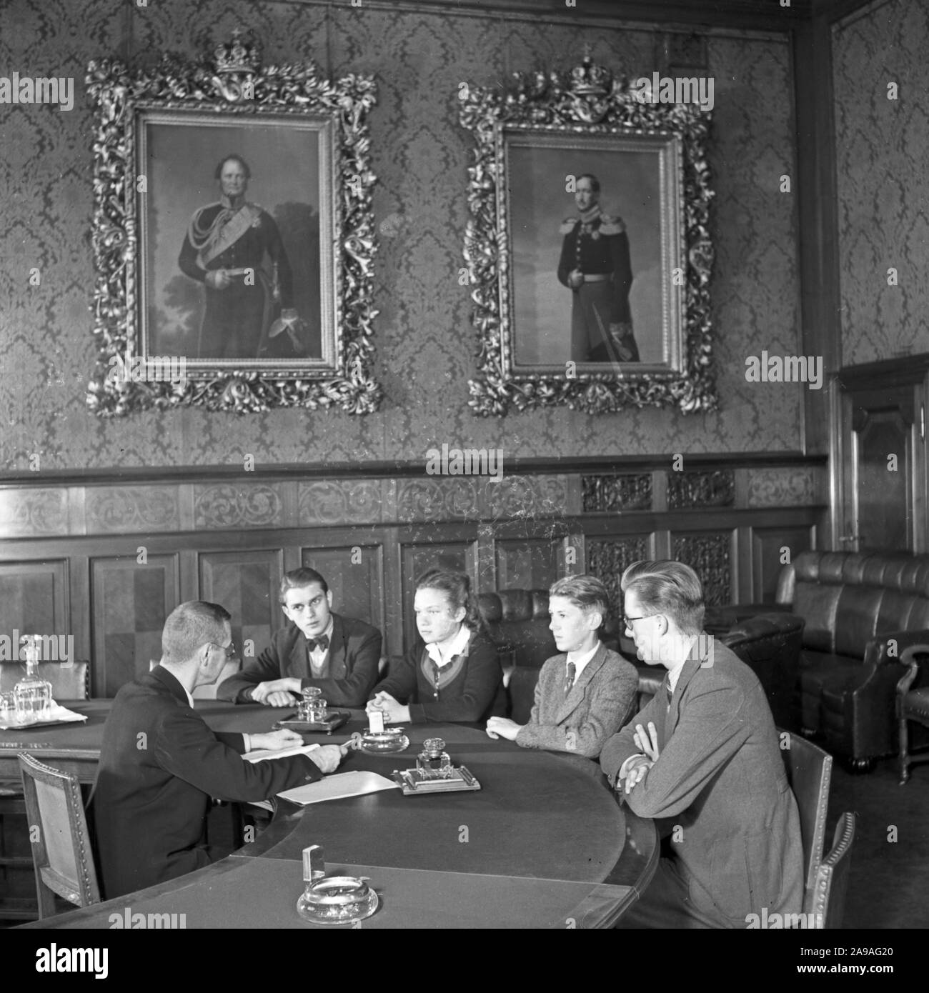 Apprentices doing their final oral exam at the end of their apprenticeship in a bank, Germany 1940s. Stock Photo