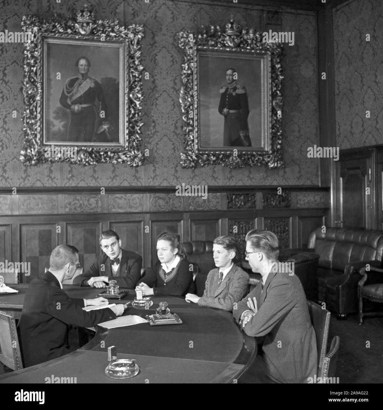 Apprentices doing their final oral exam at the end of their apprenticeship in a bank, Germany 1940s. Stock Photo