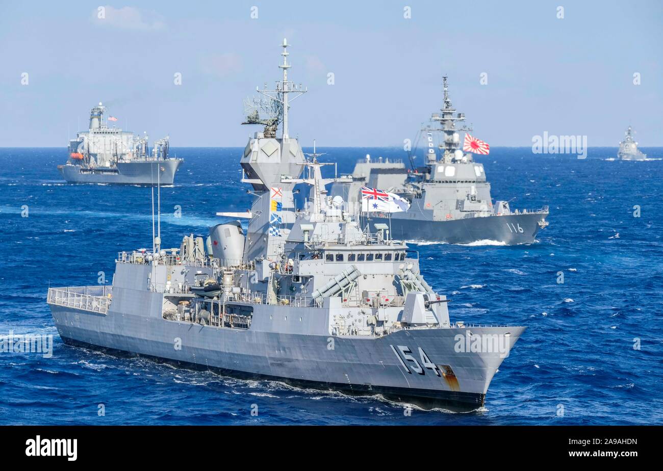 PHILIPPINE SEA (Nov. 11, 2019) Royal Australian Navy ship the Anzac-class frigate HMAS Parramatta (FFH 154), front, a Japan Maritime Self-Defense Force surface contact ship, center, and the underway replenishment oiler USNS Pecos (T-AO 197) sail in formation during Annual Exercise (ANNUALEX) 19. ANNUALEX 19 is a bilateral exercise which further develops coordination and interoperability of the premier alliance between the U.S. Navy and JMSDF. (U.S. Navy photo by Chief Operations Specialist Michael Ojeda) Stock Photo