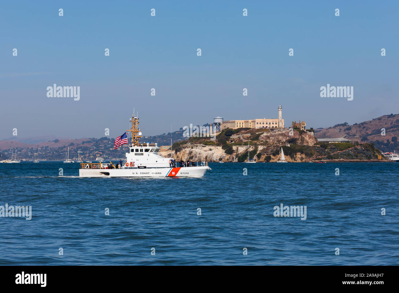 US Coastguard patrol boat, Hawksbill, passes by Alcatraz prison, in San Francisco bay, California, United States of America. USA Stock Photo
