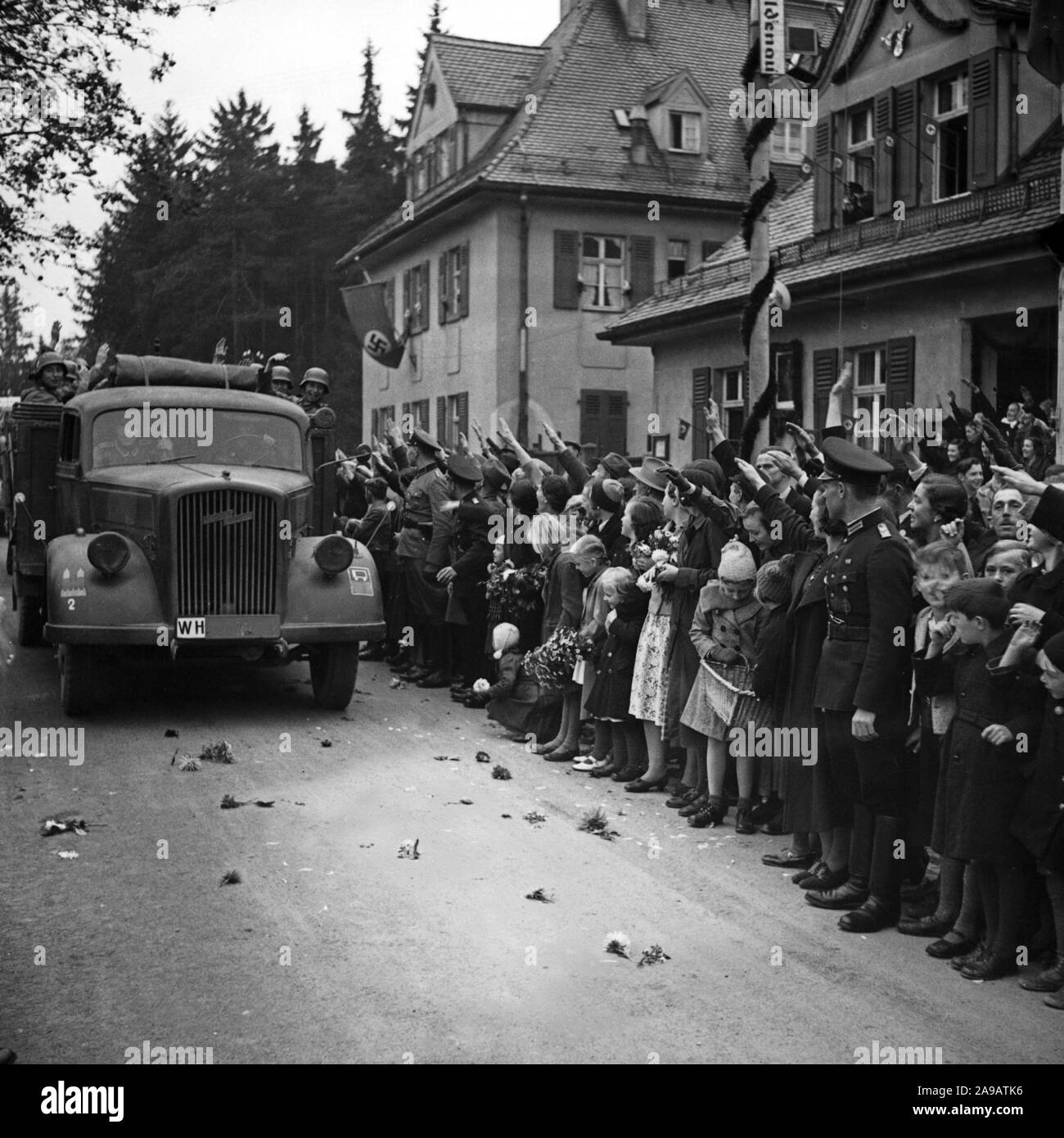 People in the streets cheering to Fuehrer and chancellor Adolf Hitler visiting the city of Asch in Sudetenland county, Germany 1930s. Stock Photo