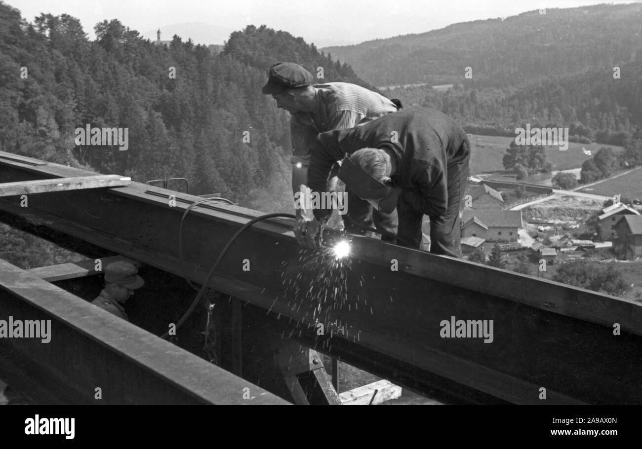 Worker welding on a railway bridge, Germany 1940s Stock Photo Alamy