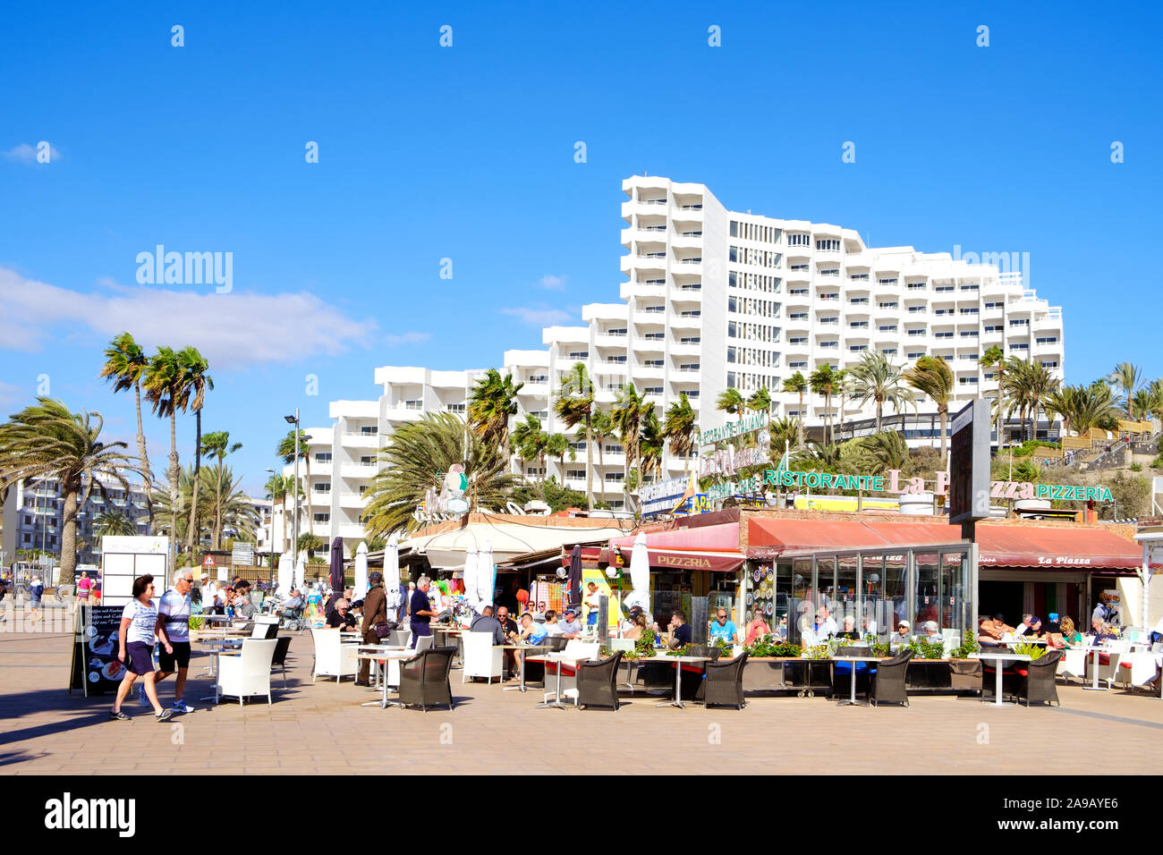 MASPALOMAS, SPAIN - JANUARY 23, 2019: Vacationers at the restaurant terraces of Playa del Ingles, in Maspalomas, in the Canary Islands, Spain, a popul Stock Photo
