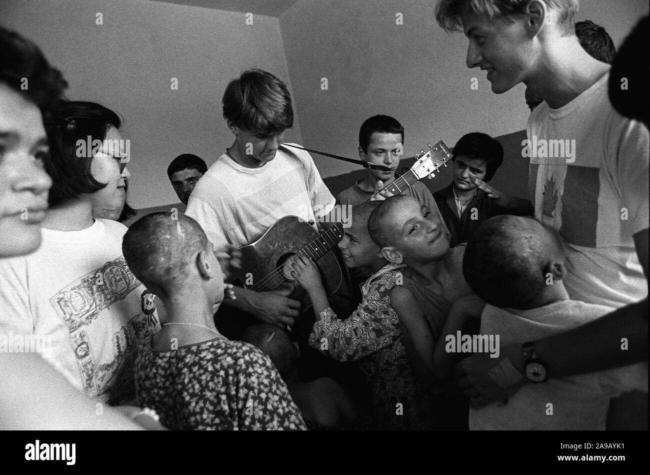 Hospital for mentally and physically handicapped children, with religious Westerners singing to them about Jesus, Shkodra, Albania, 1992. Stock Photo