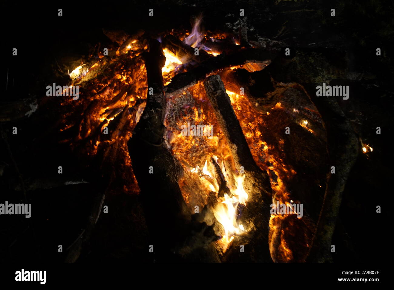 Classic Camping Campfire In Rock Fire Ring At Dusk Closeup Fire