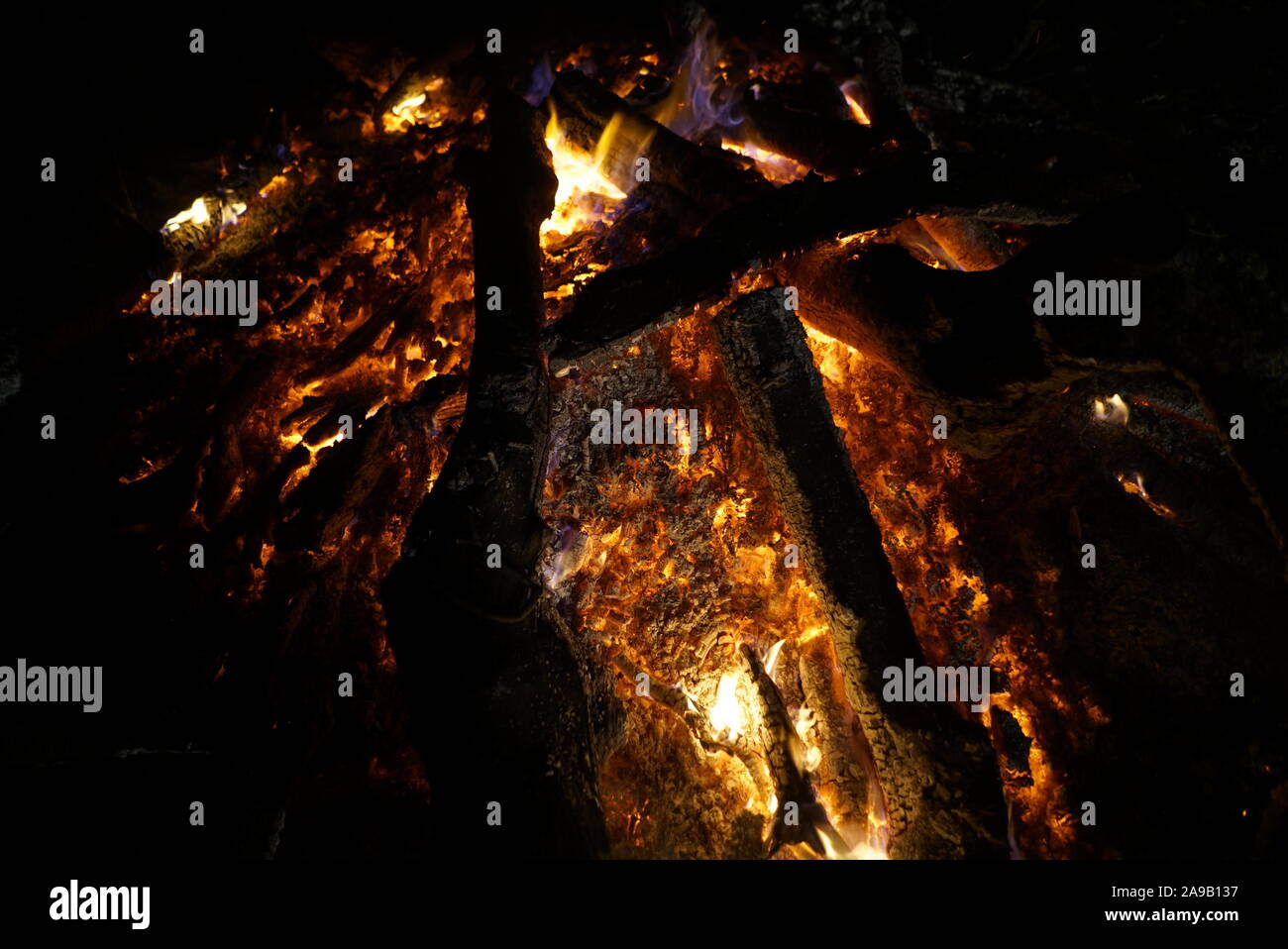 Classic Camping Campfire In Rock Fire Ring At Dusk Closeup Fire