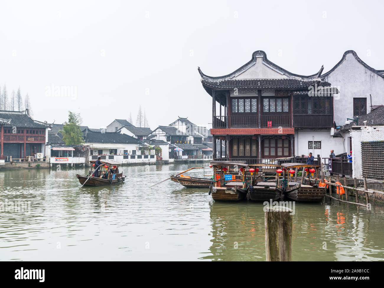 Tourist boats sailing at the canal river in Zhujiajiao, an ancient water town in Shanghai, built during Ming and Qing Dynasties, the various spans are Stock Photo