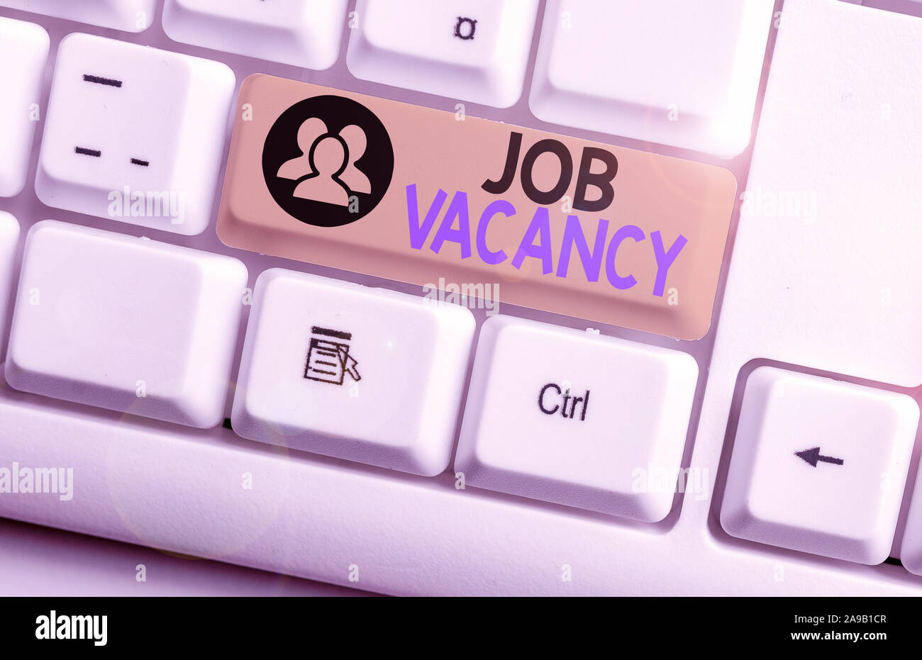 Text sign showing Job Vacancy. Business photo text job that no one is doing and available for someone to do White pc keyboard with empty note paper ab Stock Photo