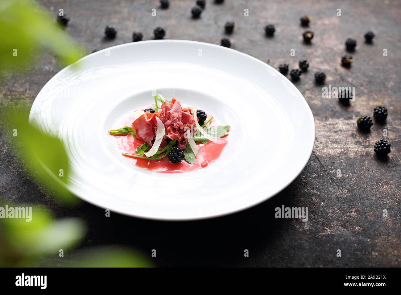 Beef carpaccio served on raspberry and blackberry mousse. Appetizer Stock Photo Alamy