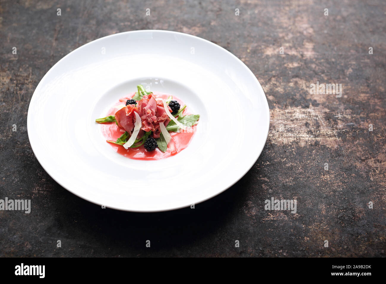 Beef carpaccio served on raspberry and blackberry mousse. Appetizer Stock Photo Alamy