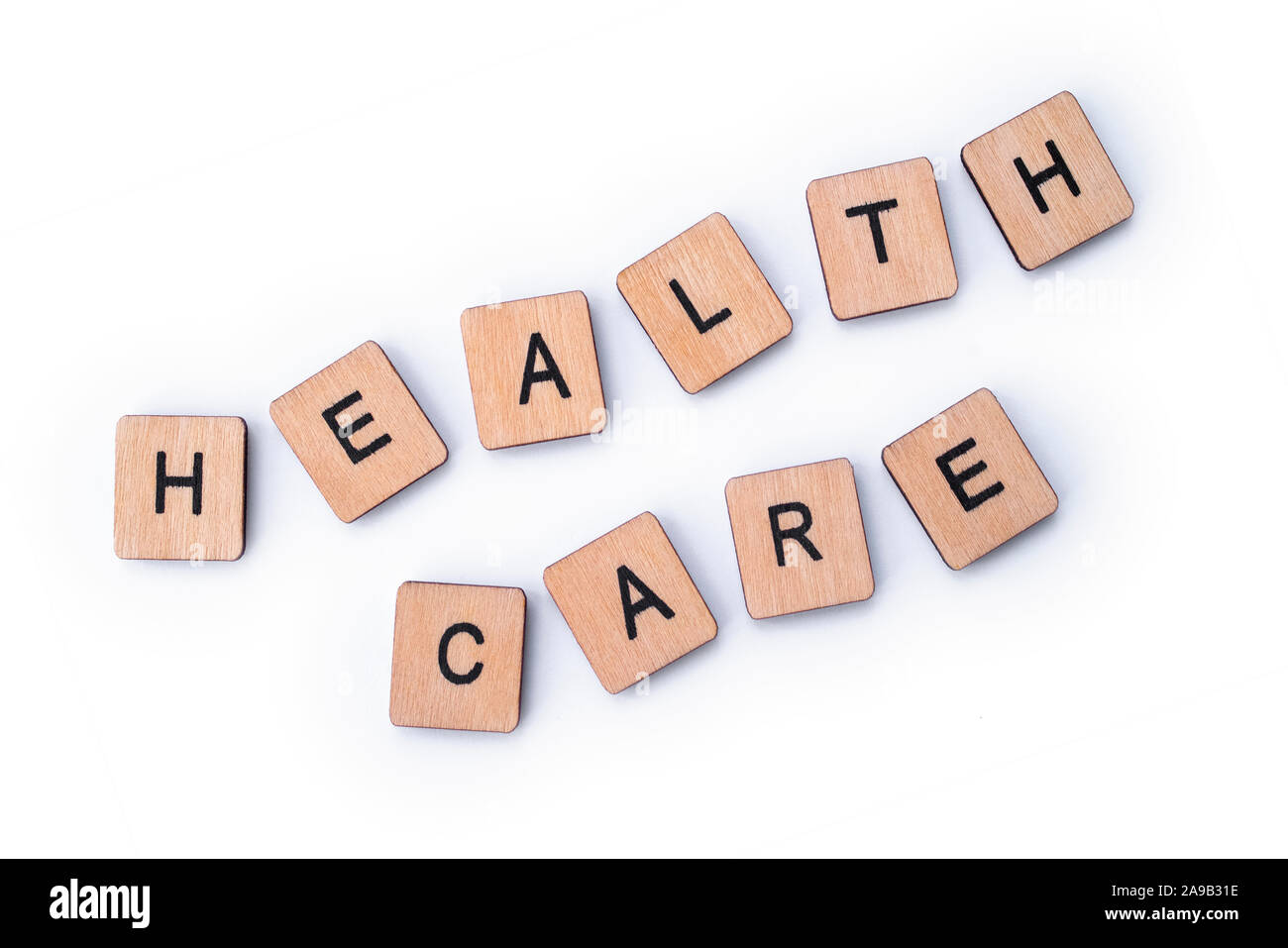 HEALTH CARE, spelt with wooden letter tiles. Stock Photo