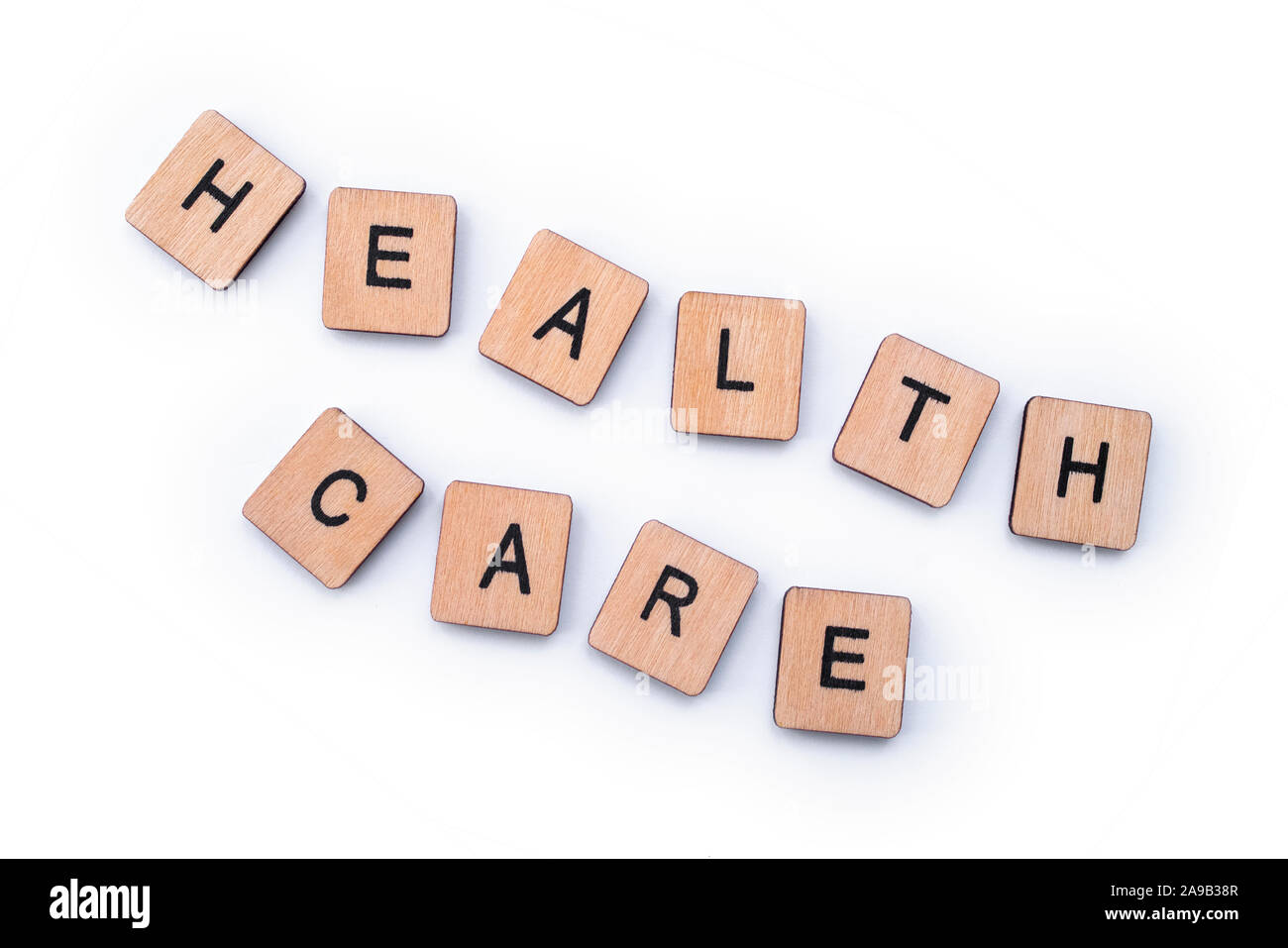 HEALTH CARE, spelt with wooden letter tiles. Stock Photo