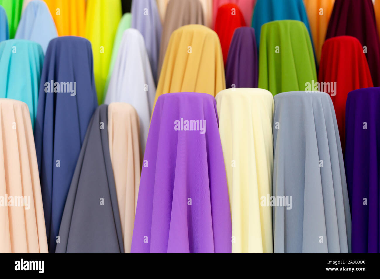 Traditional fabric store with stacks of colorful textiles at market