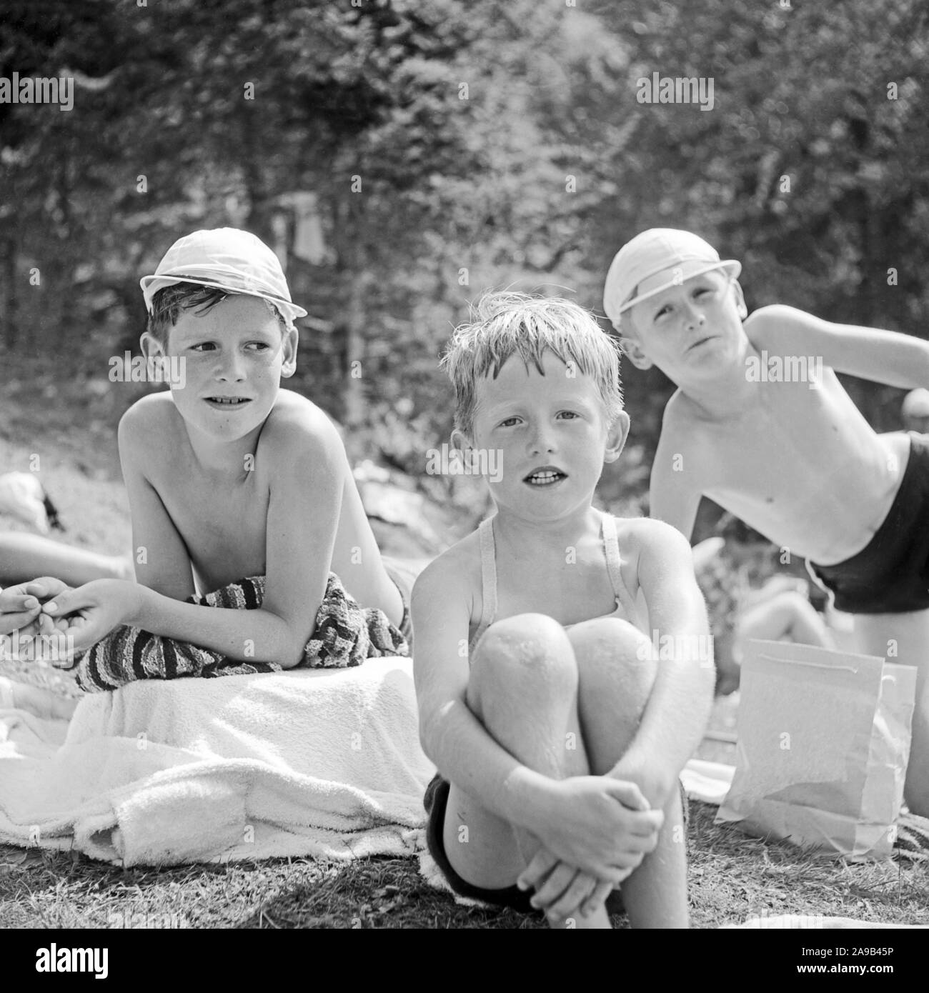 Three boys spending the day at Lautersee lake near Mittenwald, Germany 1955 Stock Photo