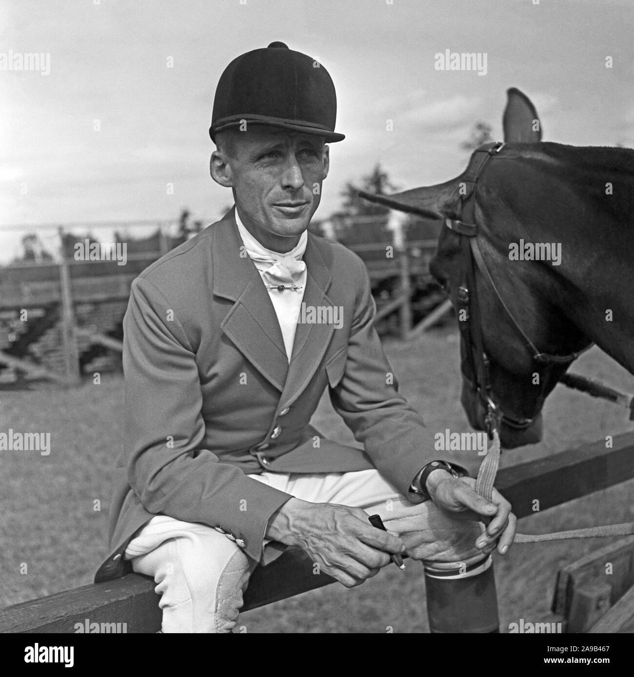 A young man wearing a jacket for an tournament in equestrian sports with is horse, Germany 1957 Stock Photo