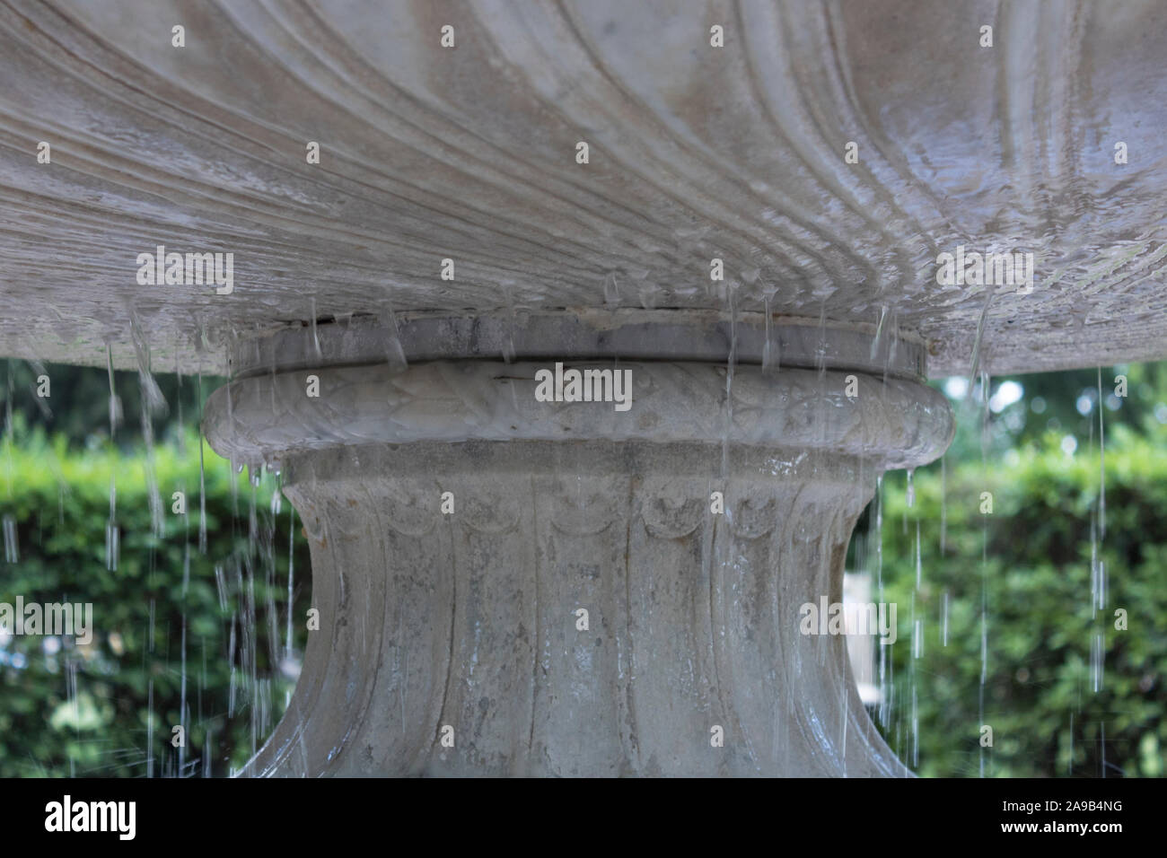 This fountain belongs to a greco roman patio in the city park. water eorsion certainly shows how old this is, but it is still in great condition. the Stock Photo