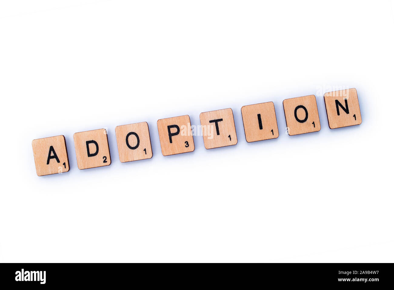 London, UK - February 6th 2019: The word ADOPTION, spelt out with wooden letter tiles. Stock Photo