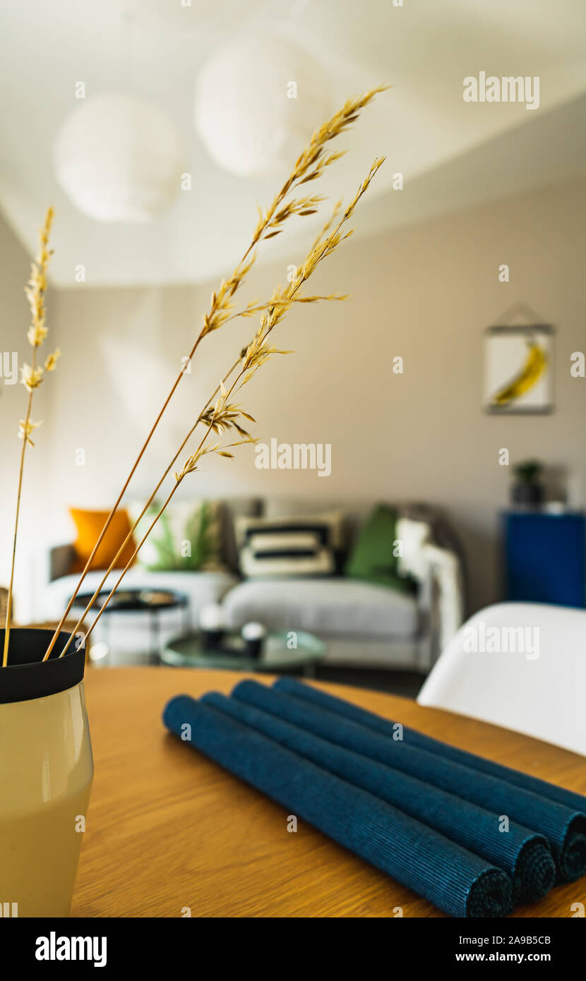 Modern,colorful, chic living room interior, close-up on vase with wheat spikes Stock Photo