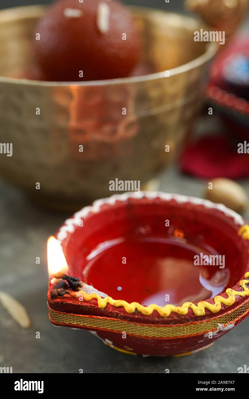 Happy Diwali background - Colorful Clay Diya lit during Deepavali festival, selective focus Stock Photo
