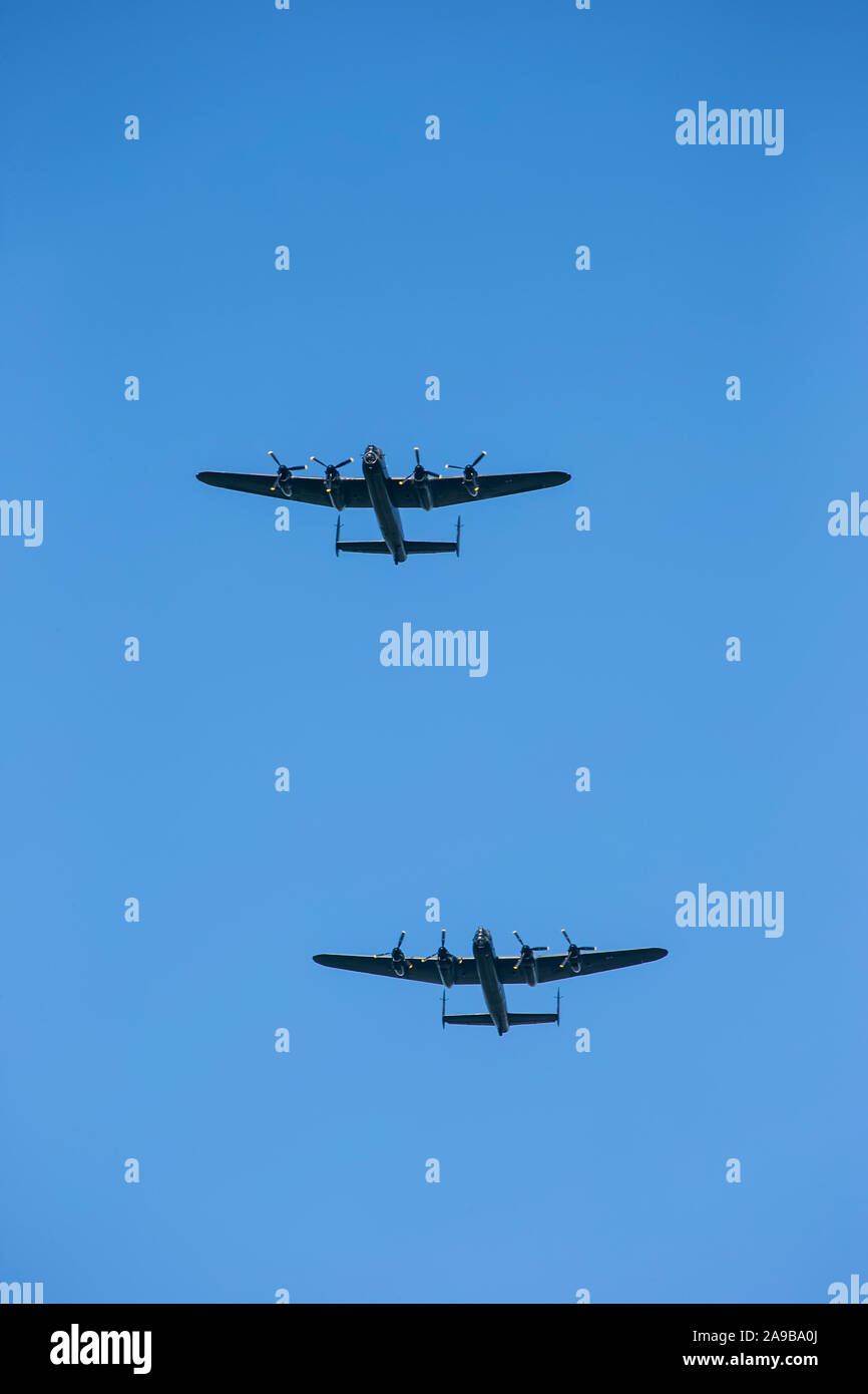 The two remaining airworthy Avro Lancaster British four-engined Second World War heavy bombers in a ceremonial flypast over Holmfirth, West Yorkshire Stock Photo