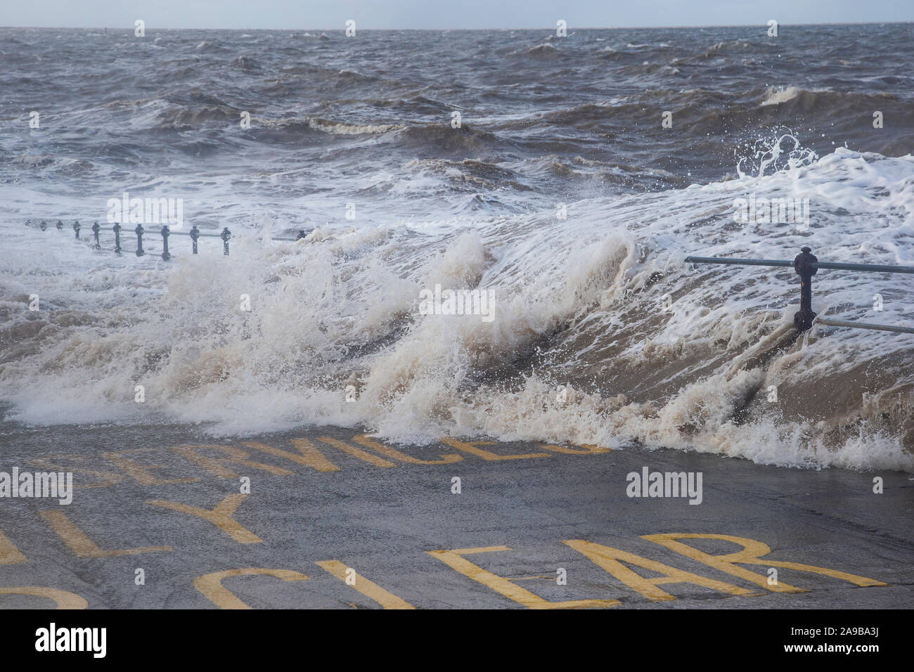 High tides and heavy storms lash the promenade at New Brighton on the