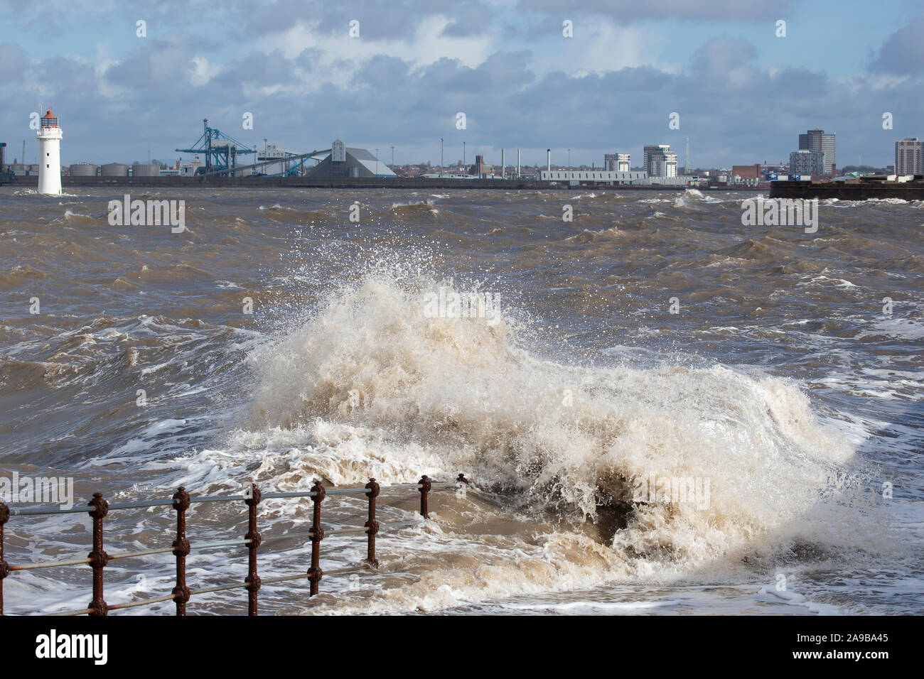 High tides and heavy storms lash the promenade at New Brighton on the Wirral, U.K. with sea spray crashing against the coastal defences Stock Photo