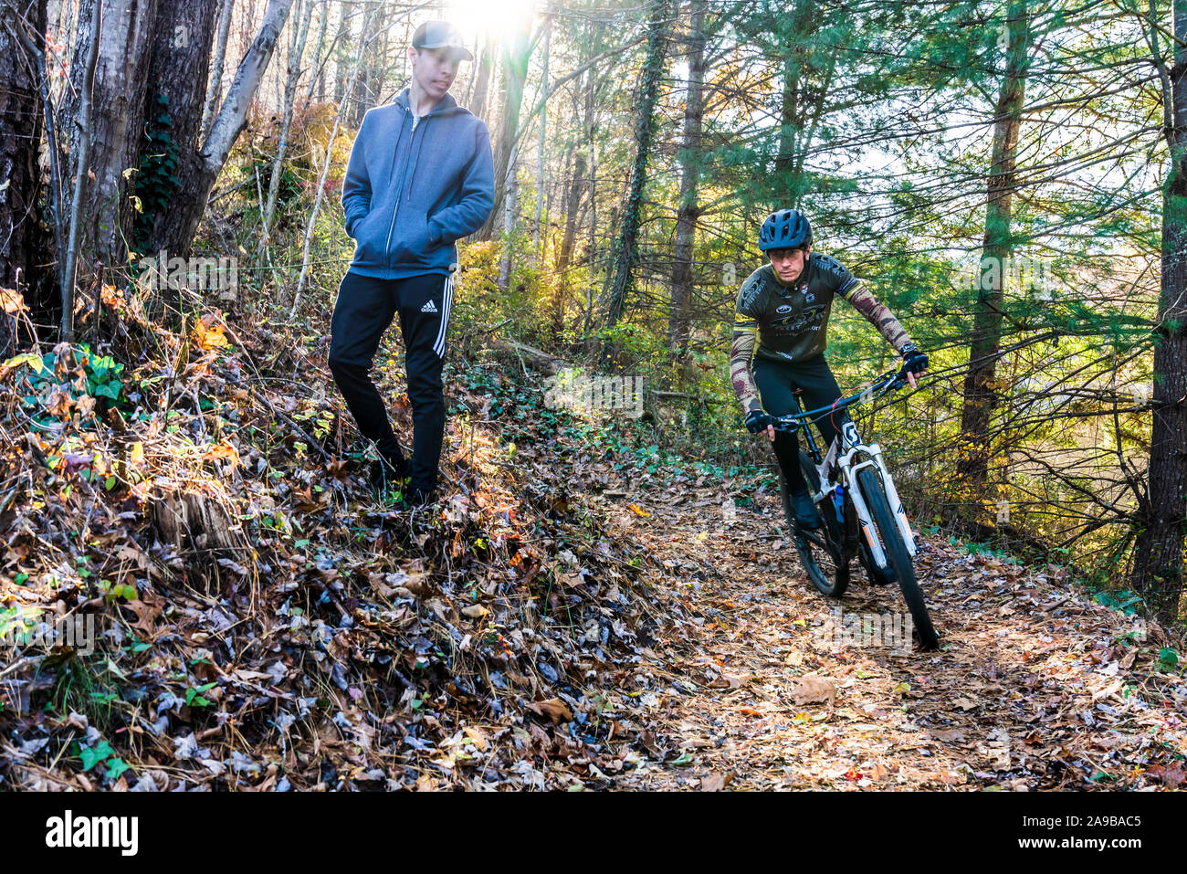 Mountain biker and a walker or runner must share this trail. Stock Photo