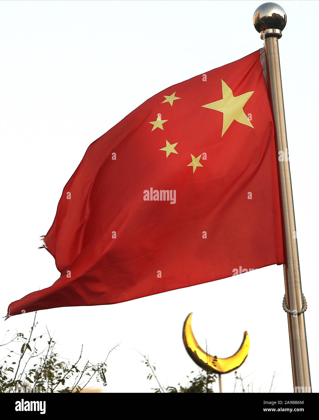 Beijing, China. 14th Nov, 2019. China's national flag flies above a Islamic mosque in Beijing on Thursday, November 14, 2019. China could be detaining far more than one million Muslims in 'concentration camps' and prisons, according to Washington-based researchers. Photo by Stephen Shaver/UPI Credit: UPI/Alamy Live News Stock Photo