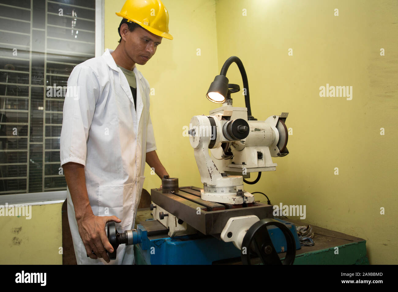 Bangladesh – May 20, 2015: A factory lab operator using Steel rod ...