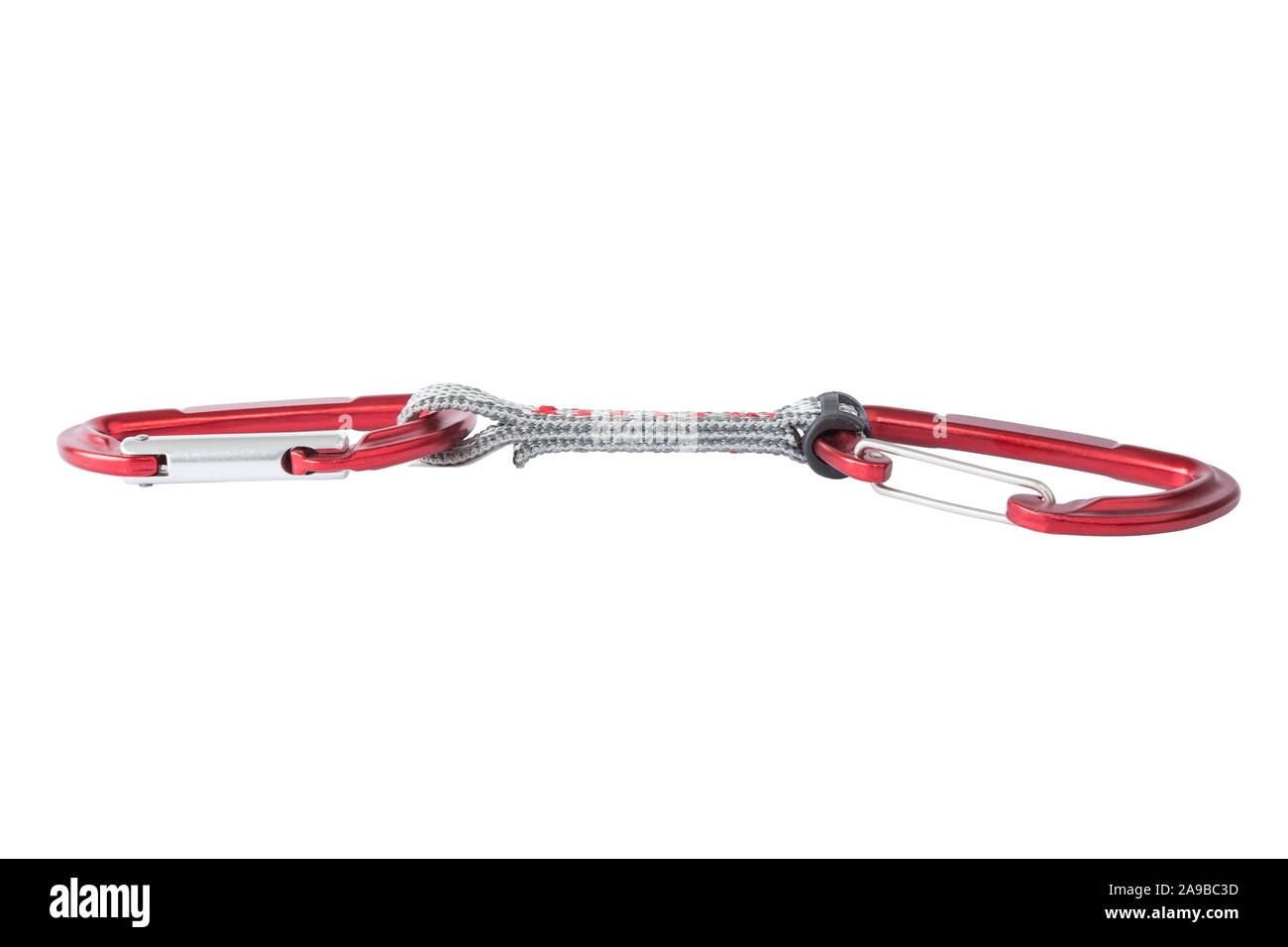 Close-up of a single red metal quickdraw carabiner for mountain and sport climbing, isolated on white background. Stock Photo