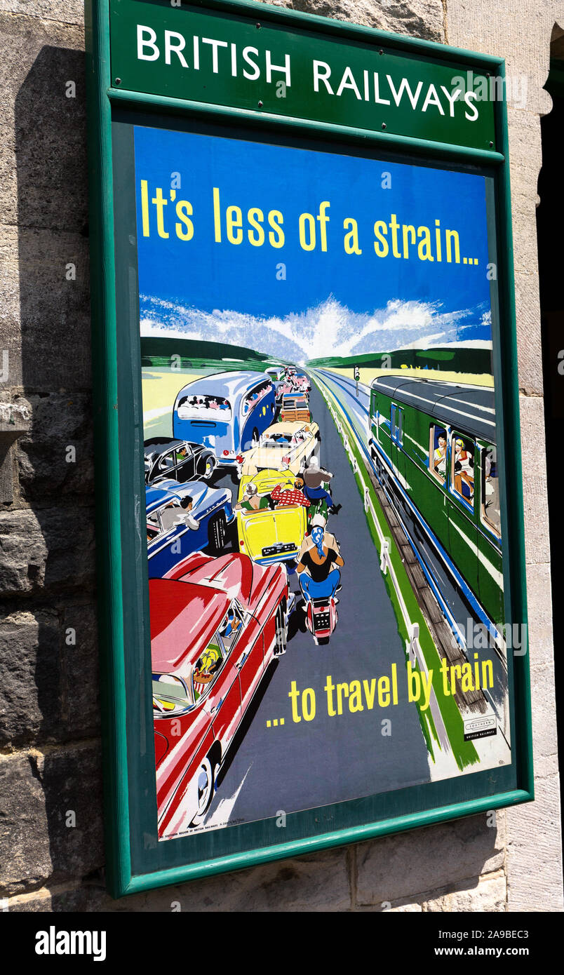 Adverts for train travel. 1950s 1960s Corfe castle Railway station Dorset England UK Stock Photo