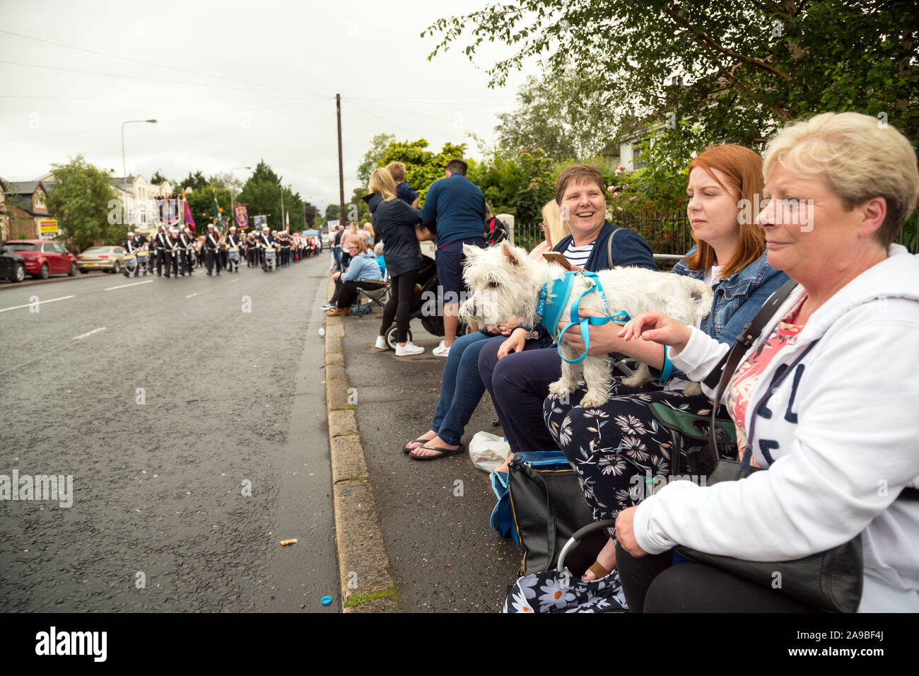 12.07.2019, Belfast, Northern Ireland, United Kingdom - Spectators at Orangemens Day, a Protestant, politically charged and annual holiday commemorati Stock Photo