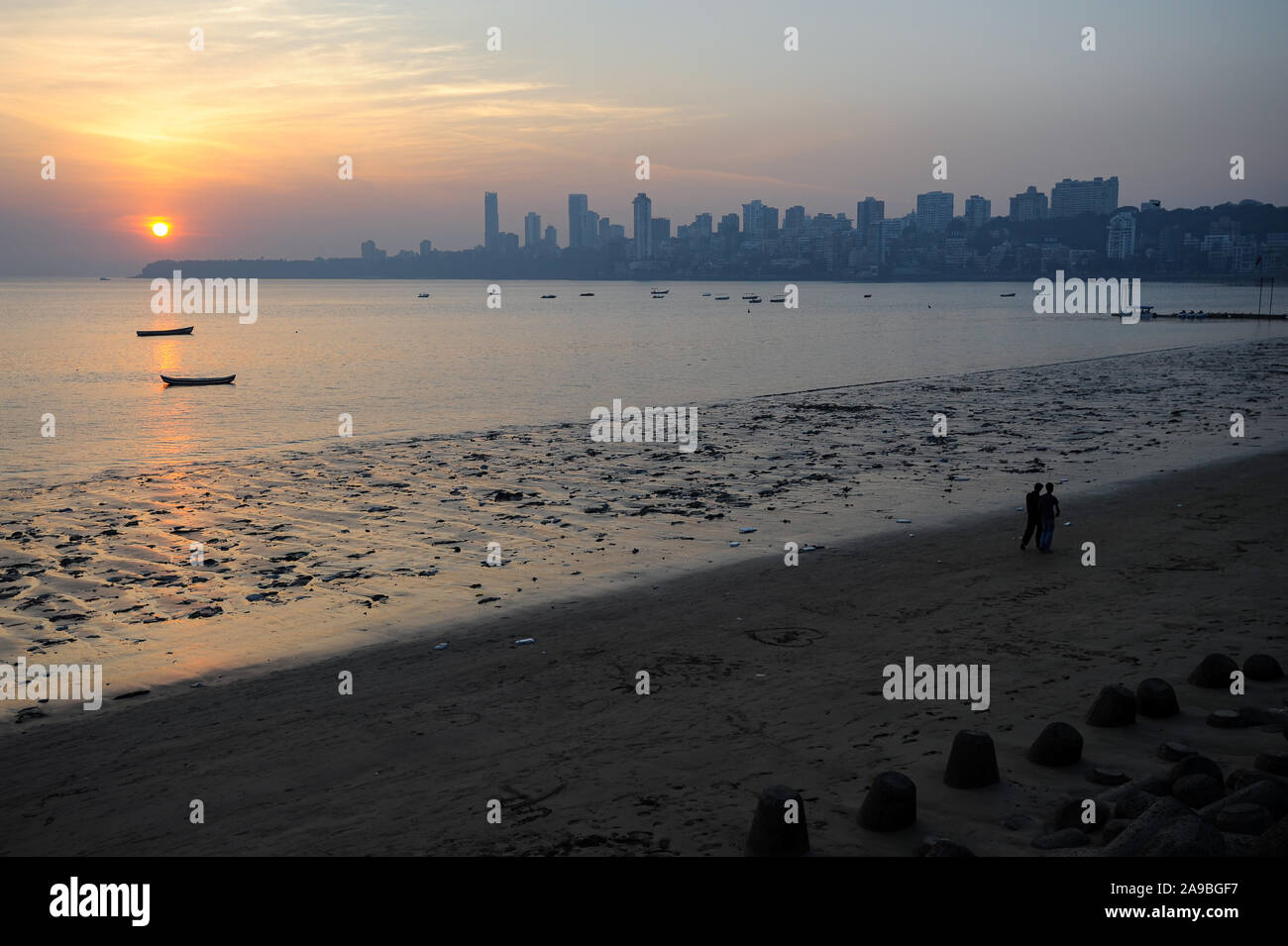 12.12.2011, Mumbai, Maharashtra, India - Sunset at Chowpatty Beach along Marine Drive with the skyline of Malabar Hill in the background. 0SL111212D00 Stock Photo