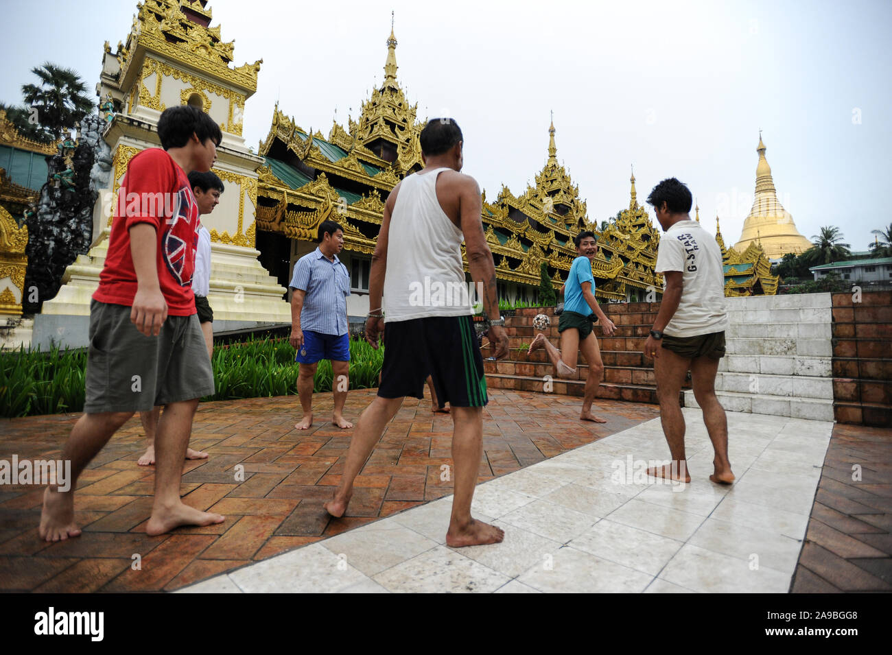 25.08.2013, Yangon, , Myanmar - A group of men plays in front of the temple area of the Shwedagon Pagoda Chinlone. The game is the national sport of t Stock Photo