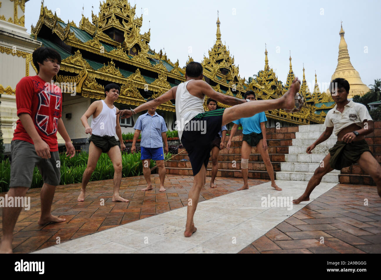 25.08.2013, Yangon, , Myanmar - A group of men plays in front of the temple area of the Shwedagon pagoda Chinlone. The game is the national sport of t Stock Photo