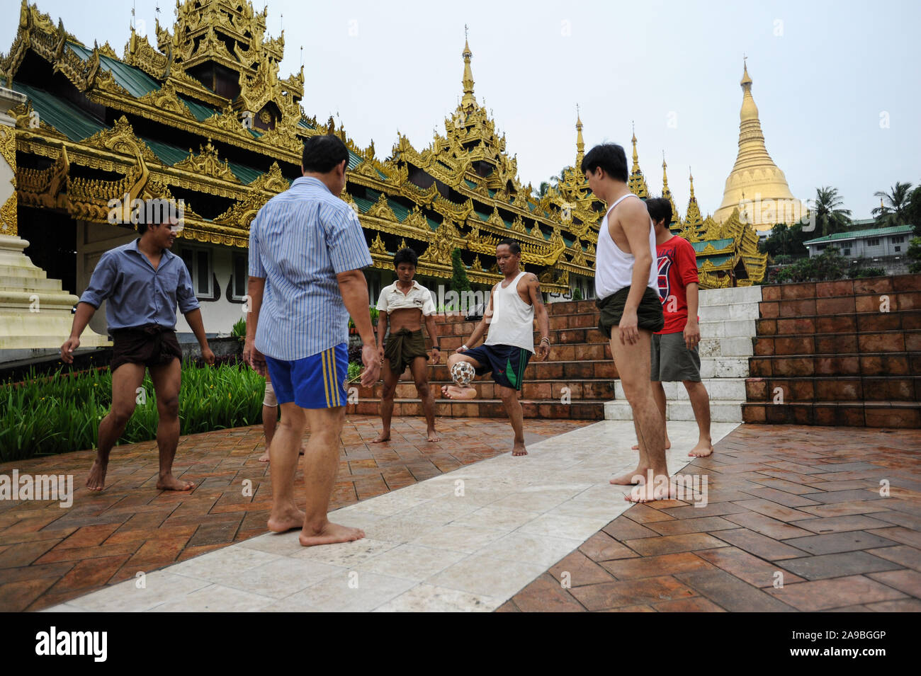 25.08.2013, Yangon, , Myanmar - A group of men plays Chinlone in front of the temple area of the Shwedagon pagoda. The game is the national sport of t Stock Photo