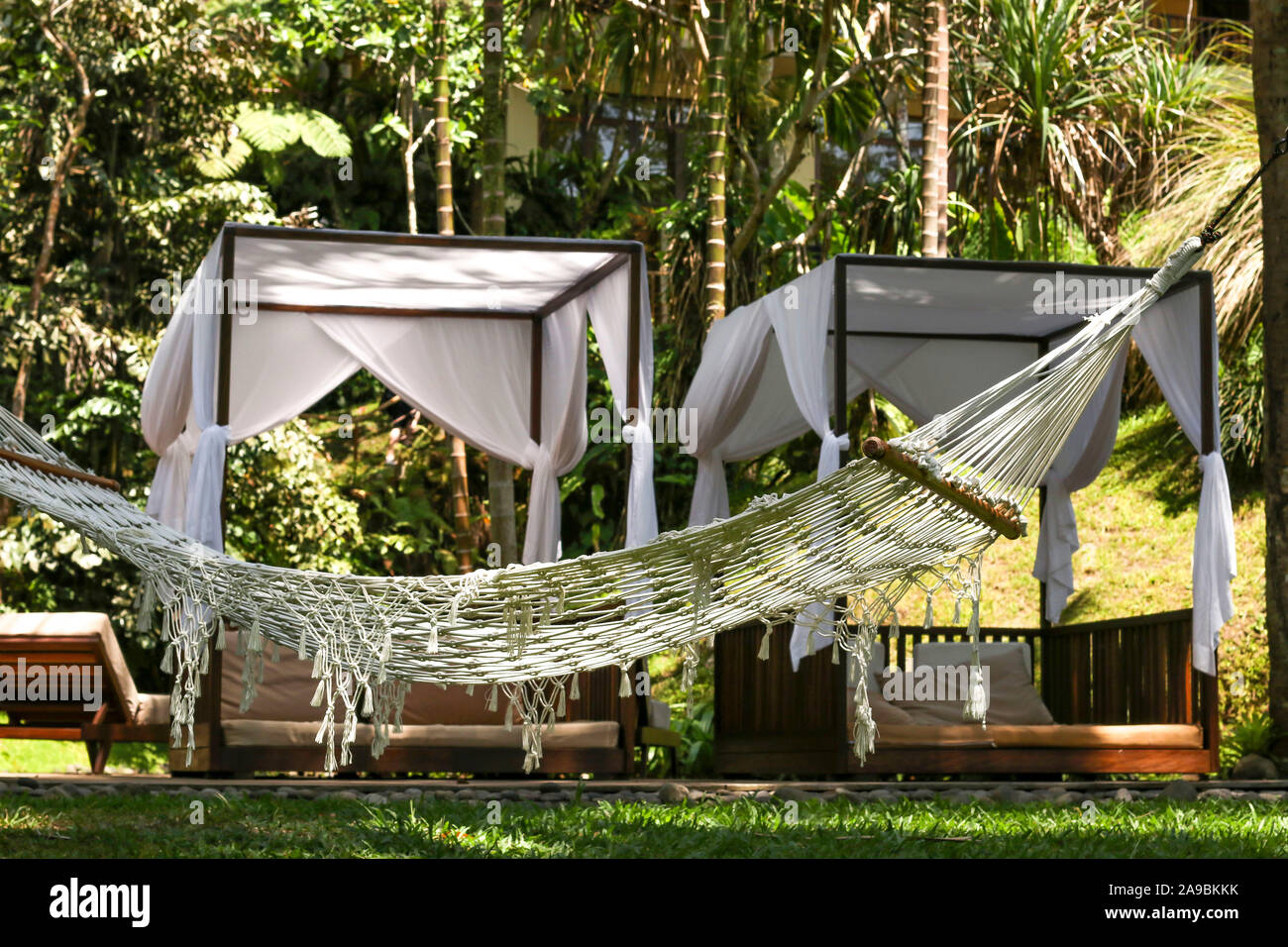Hammock on the background of cozy gazebos, a place of rest and relaxation in a beautiful