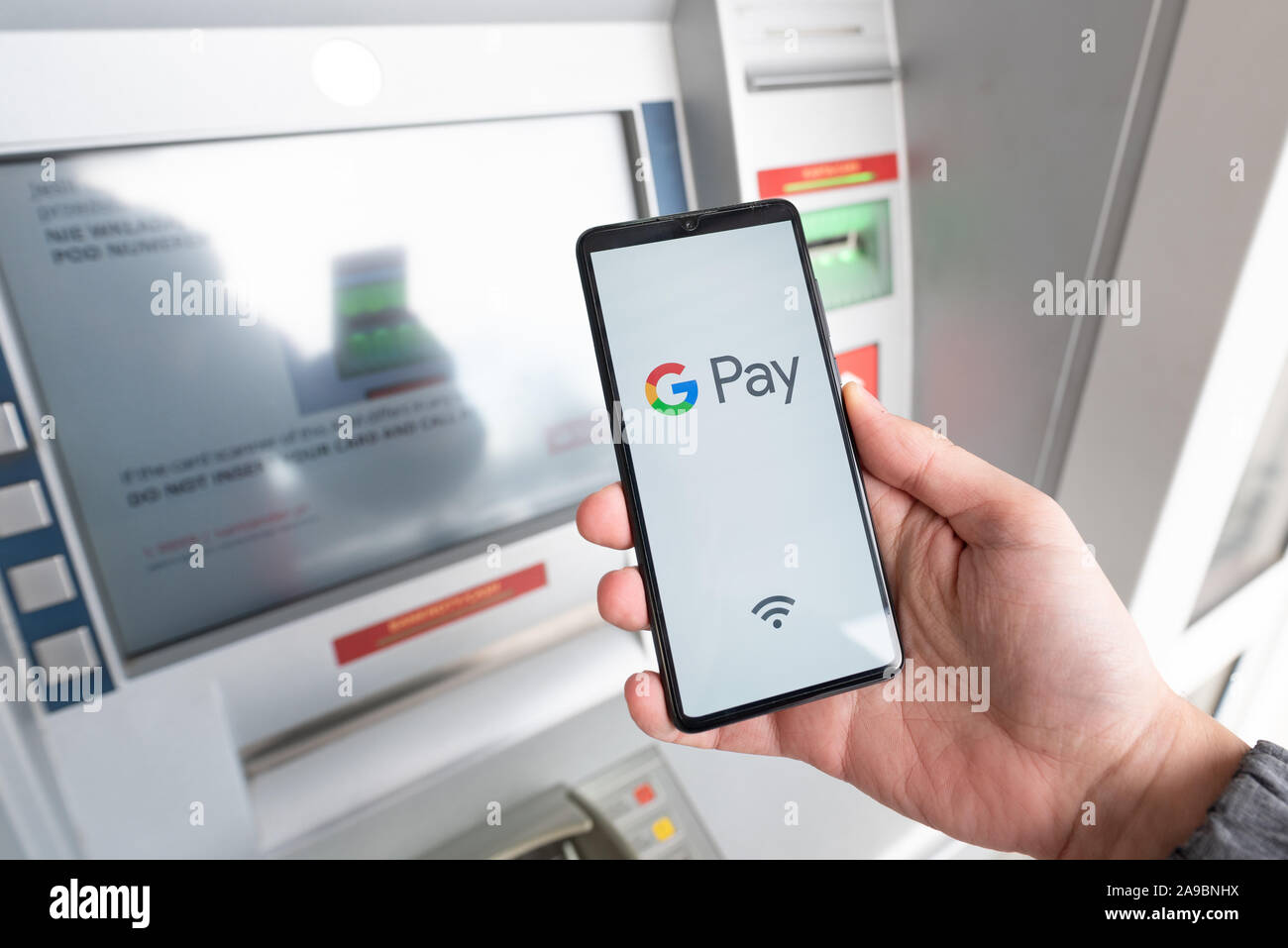 Wroclaw, Poland - NOV 06, 2019: Man holding smartphone with Google Pay logo. Google Pay is electronic wallet developed by Google. Stock Photo