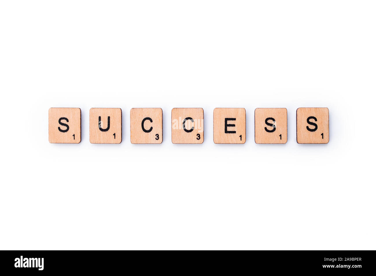 London, UK - February 13th 2019: The word SUCCESS, spelt with wooden letter tiles over a white background. Stock Photo