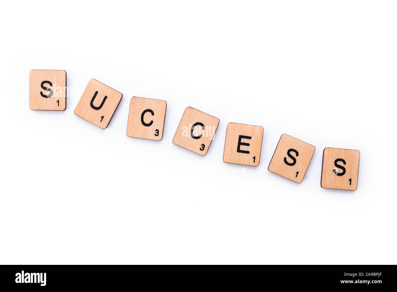 London, UK - February 13th 2019: The word SUCCESS, spelt with wooden letter tiles over a white background. Stock Photo