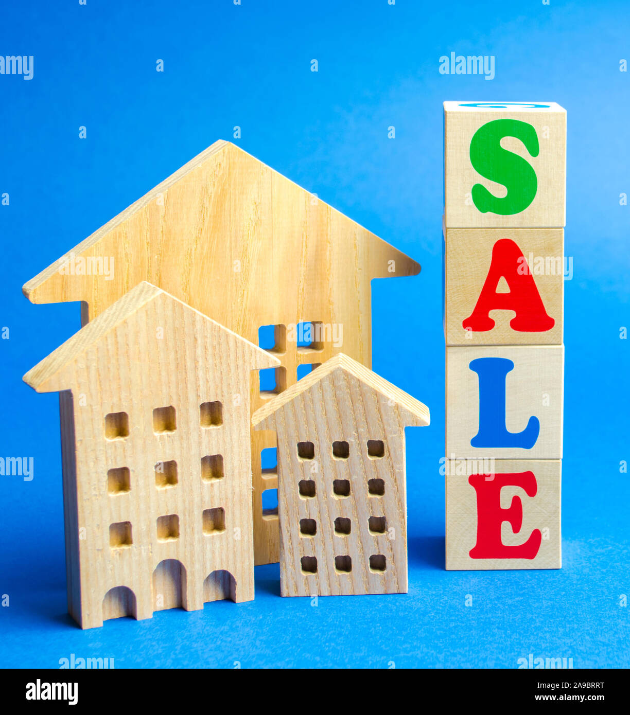 Wooden Blocks With The Word Sale And Wooden Miniature Houses The